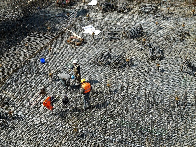 how-to-make-a-b2b-website - Construction site workers building at ground level