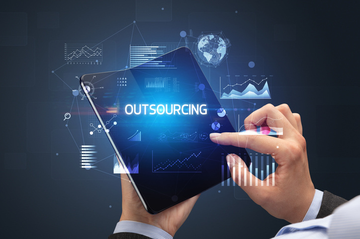 outsourcing b2b digital marketing - businessman checking metrics on tablet